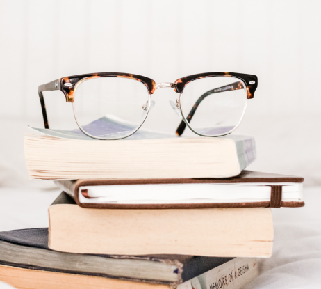 glasses on top of 5 books