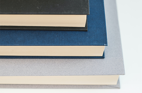 A stack of books on a wbite table