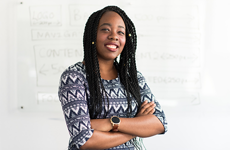 Person proudly standing in front of white board 