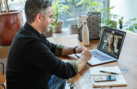 Person at their desk on a video conference call