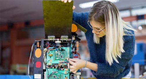 Female engineer working with technical items
