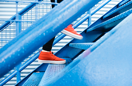 Close up image of individual running up a stairwell