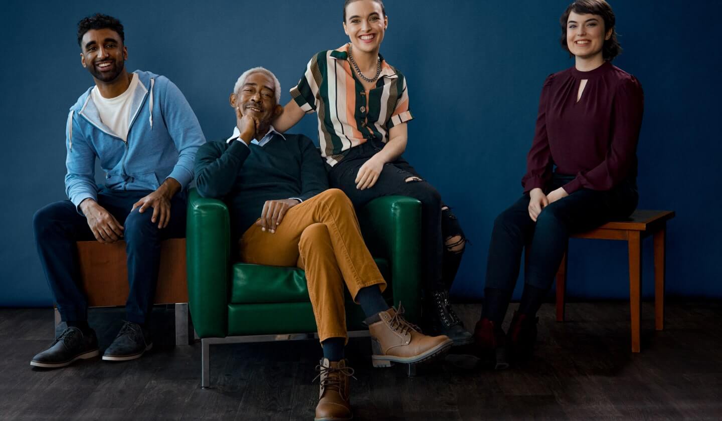 Group of professionals sitting on chairs and smiling. 