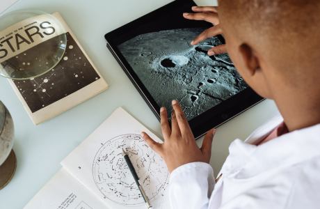 researcher using a tablet and zooming in on a planet
