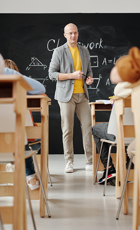 Teacher standing in front of students in a class